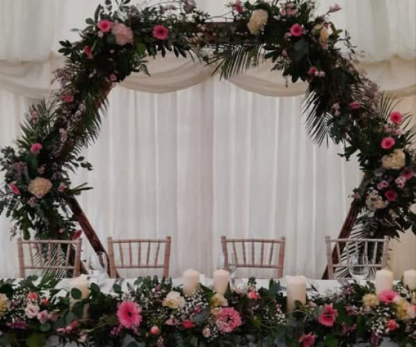 Wedding reception table centres and cake flowers by K Flowers