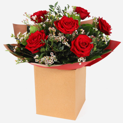 Heart’s Desire - A classic hand-tied bouquet of elegant red roses, beautifully arranged with fresh foliage and seasonal accents for a timeless romantic gift.