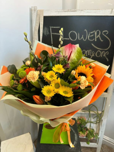 Brighten My Day - A vibrant hand-tied bouquet in cheerful yellow, orange and green tones, beautifully arranged with seasonal flowers to brighten any occasion.
