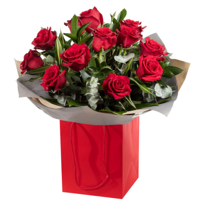 12 Red Roses - A striking bouquet of 12 rich red roses, beautifully complemented by crisp white accents and lush greenery.